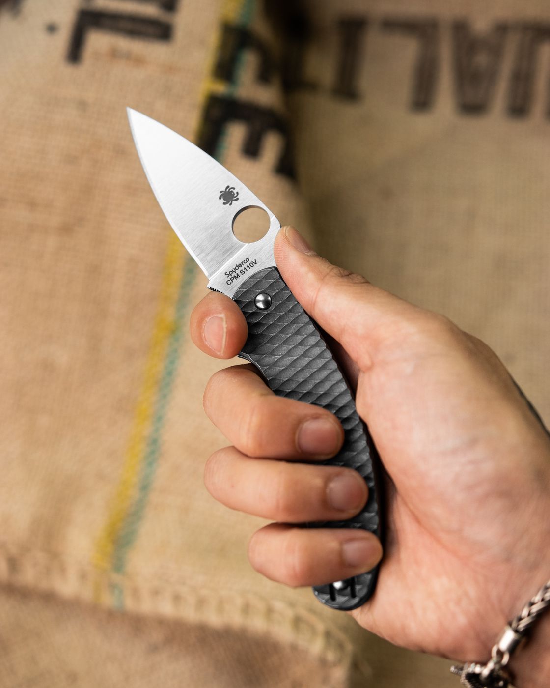 Spyderco folding knife with Spyderhole held open in hand